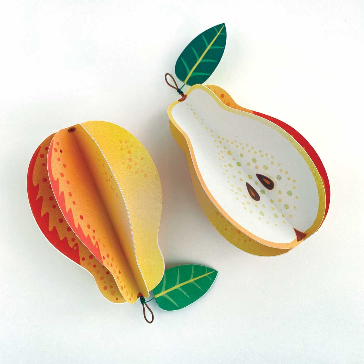 two paper pears on a white background