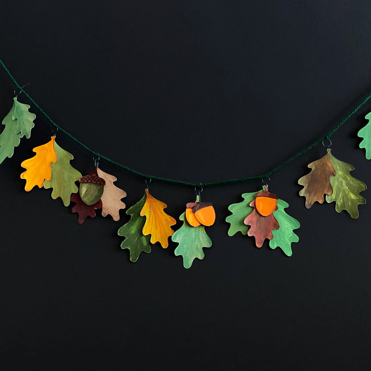 Final DIY acorn and leaf garland hanging with adjustments, created with Cakewalk DIY Paper Craft tutorial.