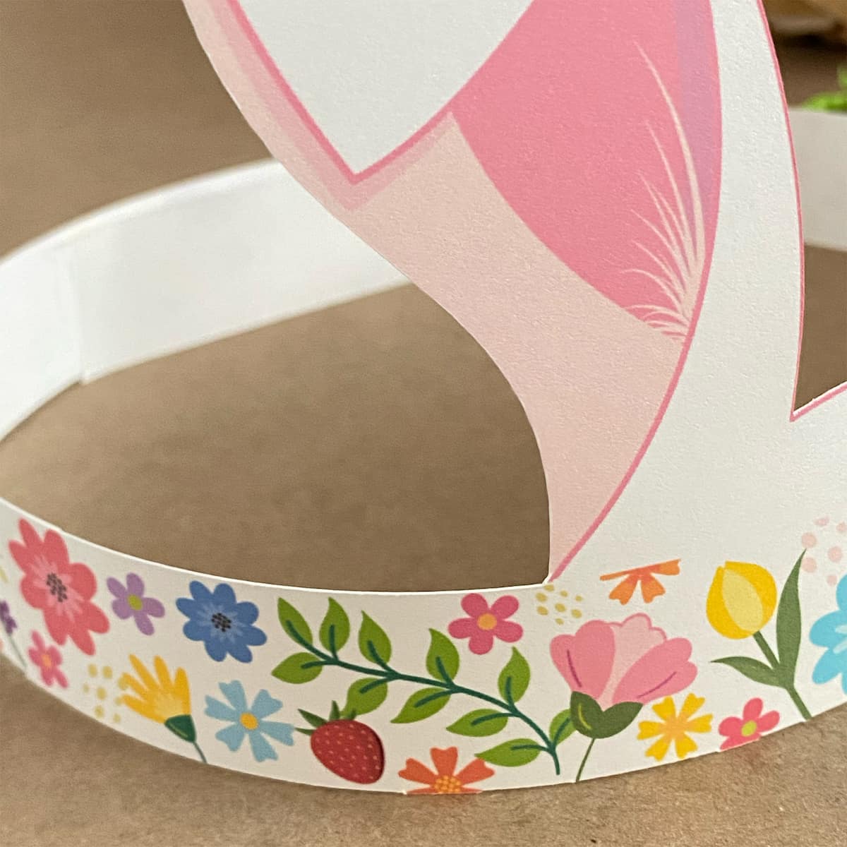 Close-up detail of colorful floral band on Easter bunny crown headband, right side