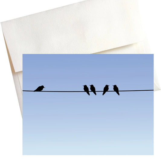 A cute illustration of silhouetted birds perched on a telephone wire against a vibrant blue sky.